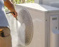 man cleaning outdoor unit